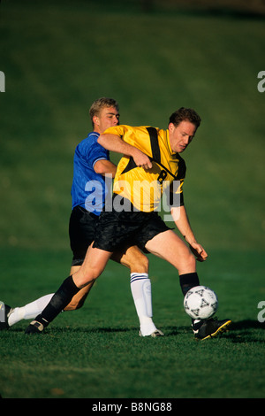 Male soccer players in action Stock Photo