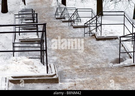 Winter stairs covered with sand to improve friction. Stock Photo