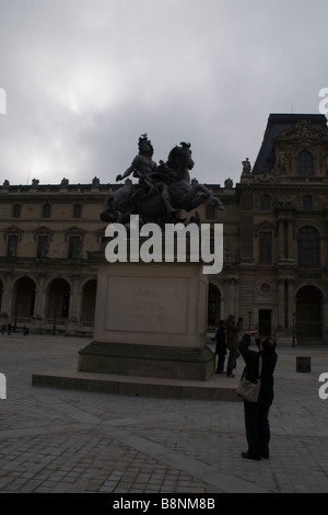 Statue of 'Louis XIV' outside the entrance of  Louvre Museum Stock Photo