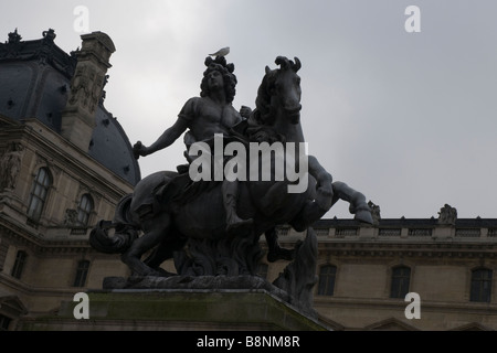 Statue of 'Louis XIV' outside the entrance of  Louvre Museum Stock Photo