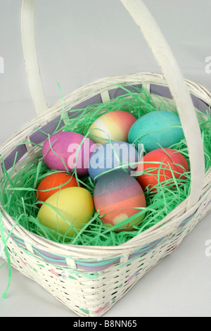 Easter basket filled with colored eggs Stock Photo
