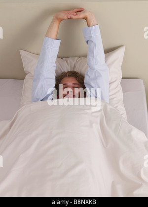 young man in bed Stock Photo
