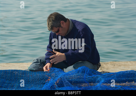 Fisherman Man Mending Repairing His Fishing Nets Santa Pola Spain Stock Photo