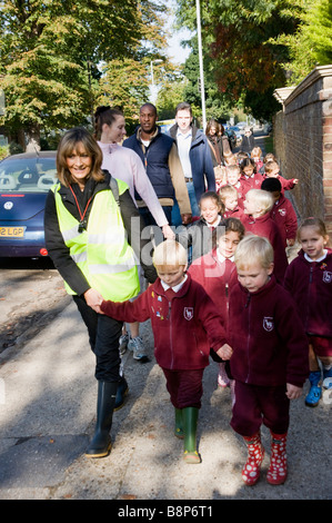 Junior school children on supervised walk with teachers Stock Photo