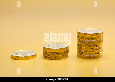 Rising stacks of £1 one pound coins sterling on gold background