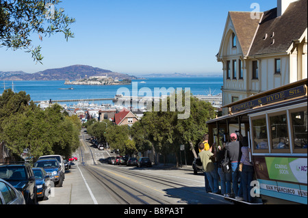 Traditional Cable Car on Hyde Street looking towards Alcatraz and Fisherman's Wharf, San Francisco, California, USA Stock Photo