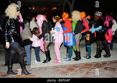 Girls in fancy dress dance the conga during a spanish carnival on the Costa Tropical southern Spain Stock Photo