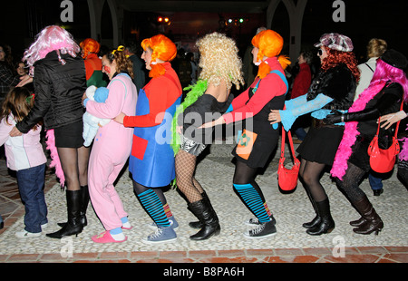 Girls in fancy dress dance the conga during a spanish carnival on the Costa Tropical southern Spain Stock Photo