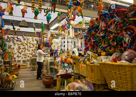 El Mercado woman clerk huge landmark Mexican shopping mall mexican souvenirs arts crafts Historic Market Square San Antonio Tx Stock Photo