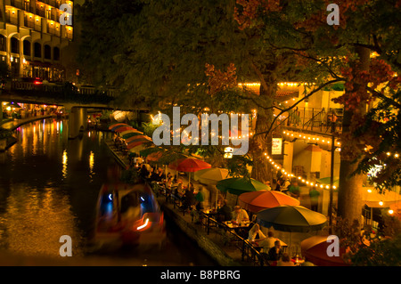 San Antonio River Walk riverwalk above at night tour boat and outdoor cafes lining the riverbank Stock Photo