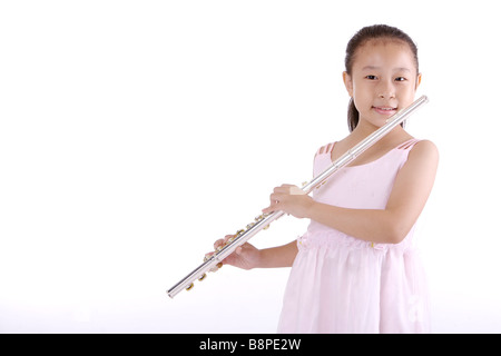 Girl blowing flute smiling portrait Stock Photo