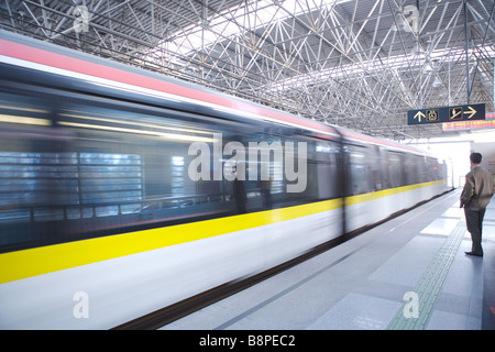 Train passing by platform Stock Photo