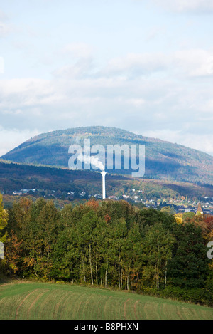 Rural landscape with smoke stack in distance Stock Photo