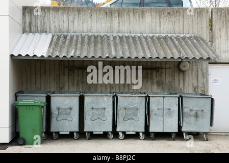 Trash bins lined up under awning Stock Photo