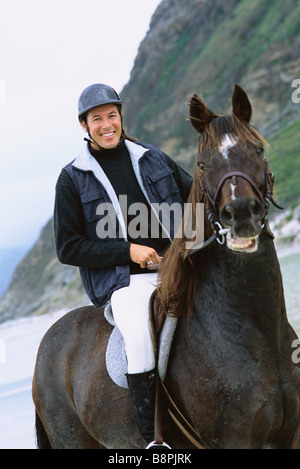 Portrait smiling man horseback riding in rural field Stock Photo - Alamy