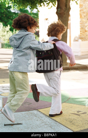 Little girls playing hopscotch together Stock Photo