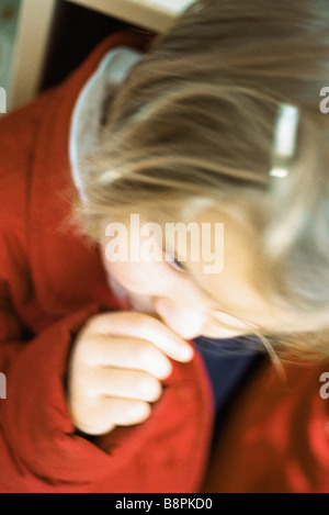 Little girl sucking thumb, defocused Stock Photo