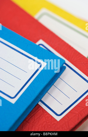 Pile of school notebooks with blank labels Stock Photo