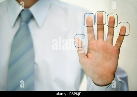 Man pressing fingertips to fingerprint reader Stock Photo