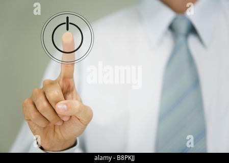 Man pressing power button Stock Photo
