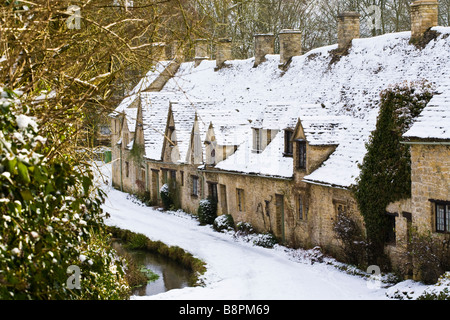 Winter snow on Arlington Row in the Cotswold village of Bibury, Gloucestershire Stock Photo