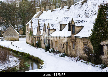 Winter snow on Arlington Row in the Cotswold village of Bibury, Gloucestershire UK Stock Photo