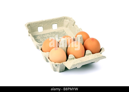 Six eggs in a cardboard egg box against a white background Stock Photo
