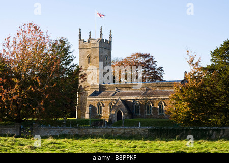 Evening sunlight falling on St Andrews church in the Cotswold village of Kingham, Oxfordshire Stock Photo