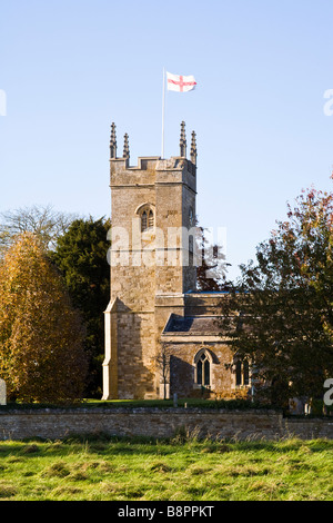 Evening sunlight falling on St Andrews church in the Cotswold village of Kingham, Oxfordshire UK Stock Photo