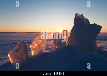 Backlit shiny ice blocks at sea ice at sunset , Finland Stock Photo
