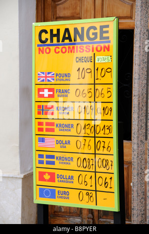 Money exchange rates list on a board outside office listing the rate of exchange for currency Stock Photo
