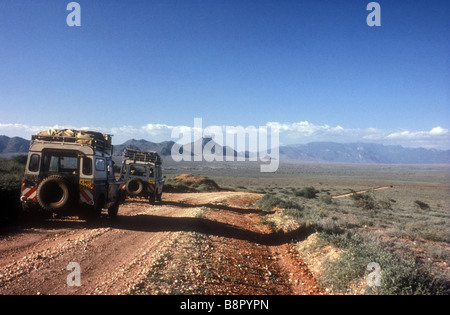 Two Landrovers on the road to South Horr from Baragoi in northern Kenya East Africa Stock Photo