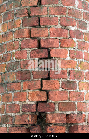 Brick wall vertical crack closeup. Stock Photo
