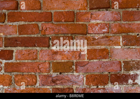 Brick building side wall partly covered with hoarfrost in winter time. Stock Photo