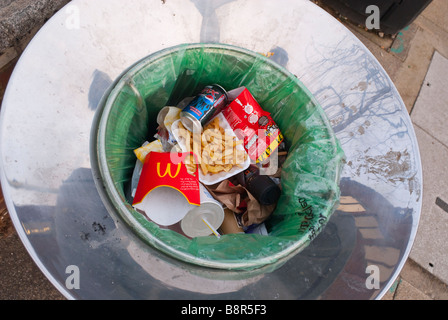 Rubbish bin with litter and trash inside it Stock Photo