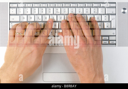two hands typing on a Apple MacBook Pro keyboard Stock Photo