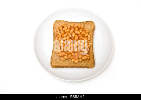 Plate of baked beans on toast isolated on a white studio background
