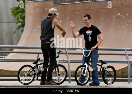 Young Men on BMX Bikes Celebrating at the Louisville Extreme Skate Park in Louisville Kentucky Stock Photo