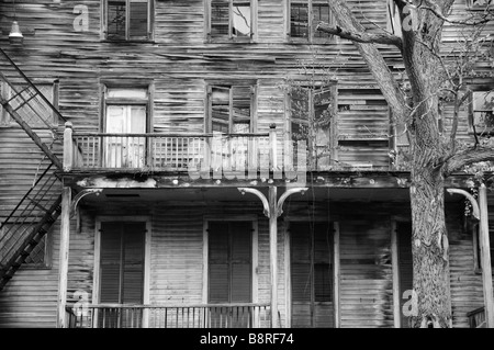 Big old decrepit house with shuttered windows Stock Photo