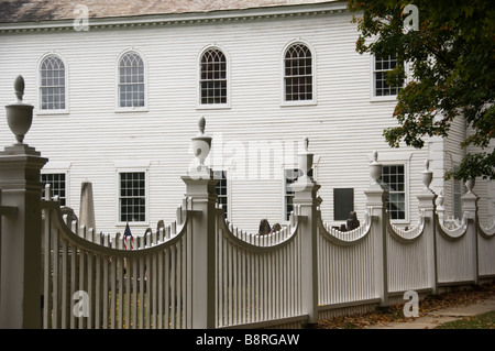 Old white picket fence around an old church Stock Photo