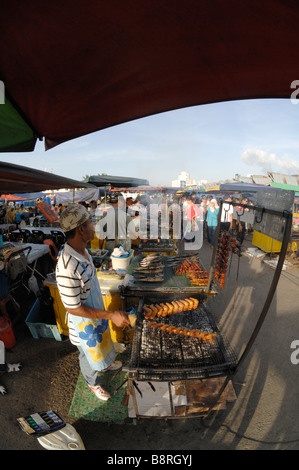 Fish cooking on barbecue at stall market waterfront Kota Kinabalu Sabah Malaysia Borneo South est Asia Stock Photo
