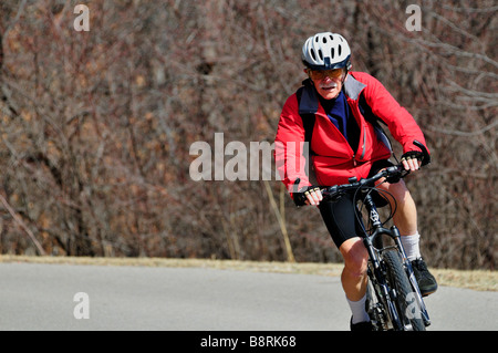 A senior man rides his bicycle on trails in Oklahoma City, Oklahoma, USA. Stock Photo