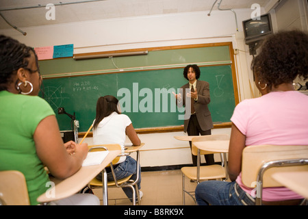 middle school teacher giving a lecture to teen students, classroom Stock Photo