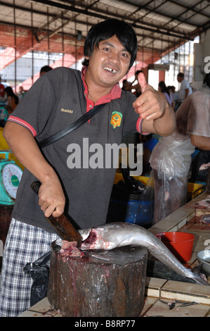 Man gutting fish interior of SAFMA fish market Kota Kinabalu Sabah Malyasia Borneo South east Asia Stock Photo