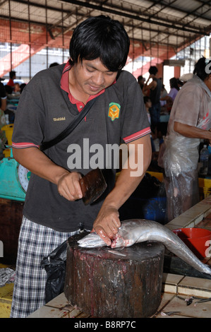 Man gutting fish interior of SAFMA fish market Kota Kinabalu Sabah Malyasia Borneo South east Asia Stock Photo