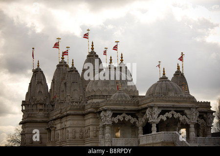 Flags and dome roofs on top of the BAPS Shri Swaminarayan Mandir London Neasden Temple Stock Photo