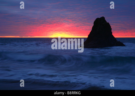 Black rock, surrounded by sea at sunset on Widemouth bay,Cornwall,southwest England,UK. Stock Photo