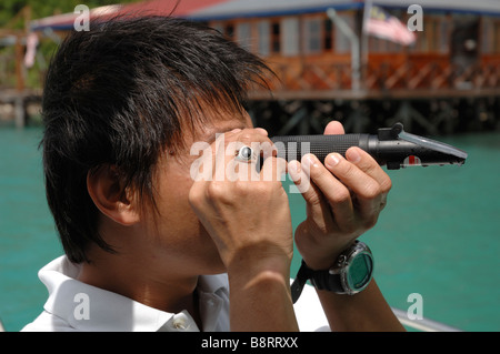 Measuring sea water salinity Sabah Parks lagoon Bohey Dulang Island Tun Sakaran Marine Park Semporna Sulu Sea Malaysia South Stock Photo