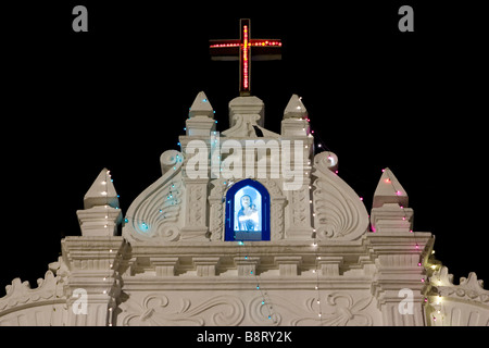 Varca catholic church view at night with illuminated statue of St. Maria in christmass garland lights decoration. Stock Photo