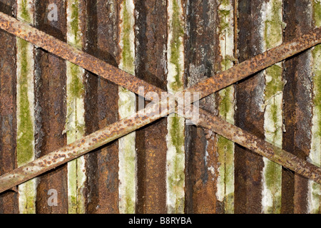 Closeup of small old rusted metal shapes with two big ones intersected. Stock Photo